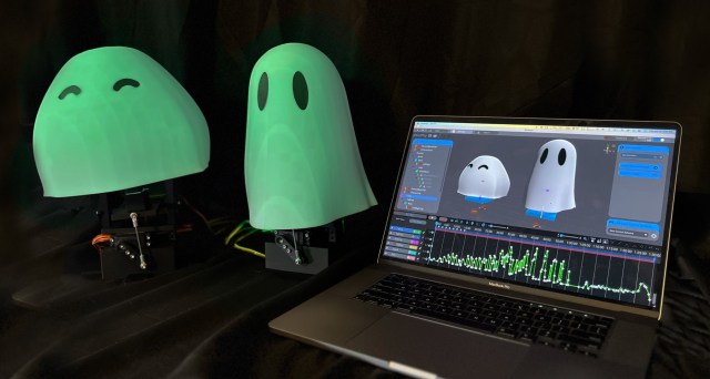 Glowing 3D-printed ghosts on animatronic controllers, next to a laptop running free motion control software